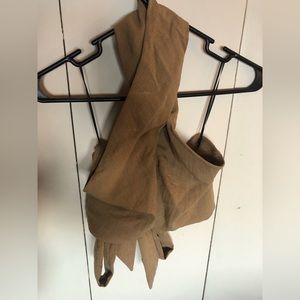 Cropped style crisscross neck halter top with tie back.